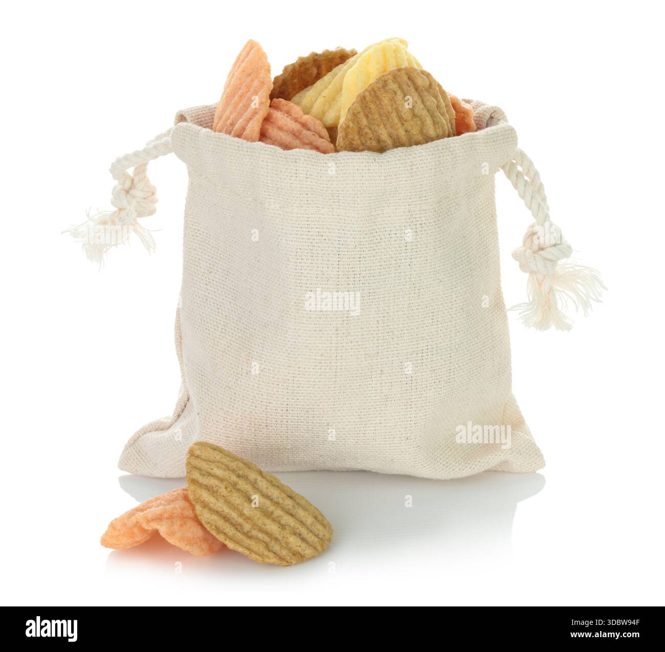 Open cotton fabric bag filled with assorted vegetable chips isolated on a transparent background. Eco friendly zero waste packaging for healthy vegan Stock Photo