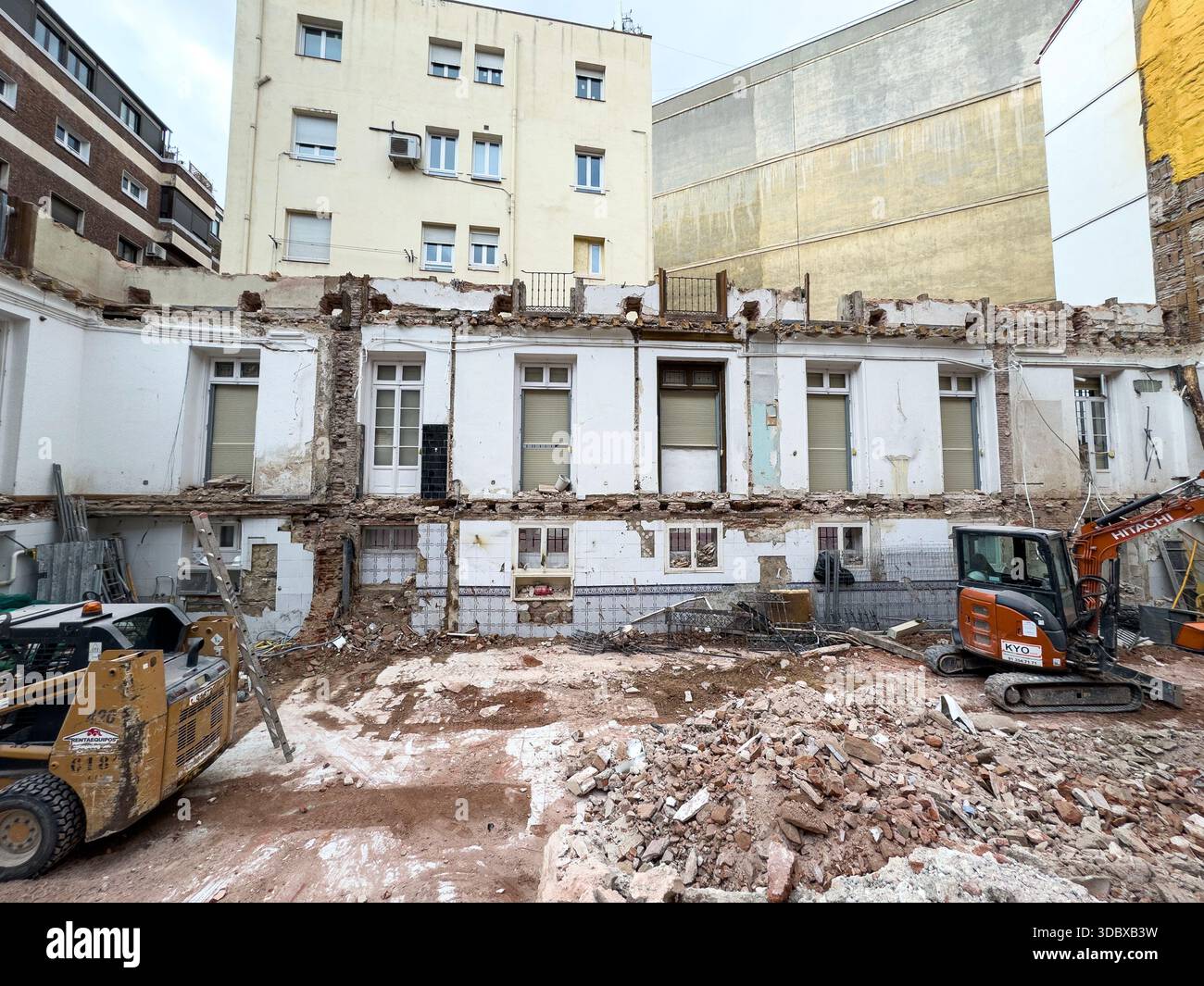 Machinery in an old building being empty to build a new apartment block in calle Cardenal Cisneros, Chamberi, Madrid, Spain - Smartphone Captured Stock Image