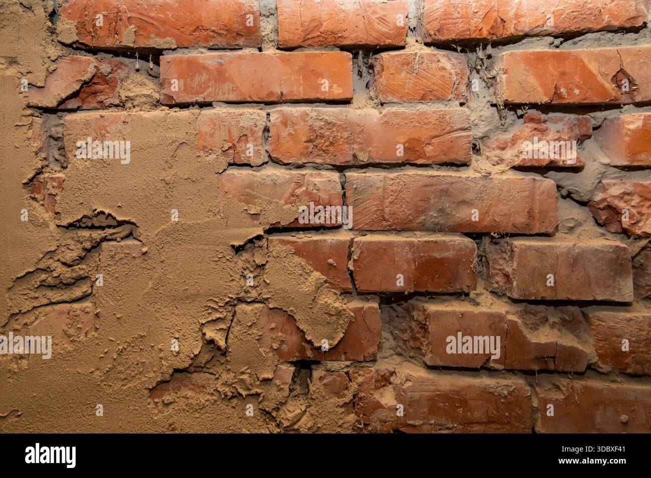 Old brick wall with plaster texture showing rough architectural surface background Stock Photo