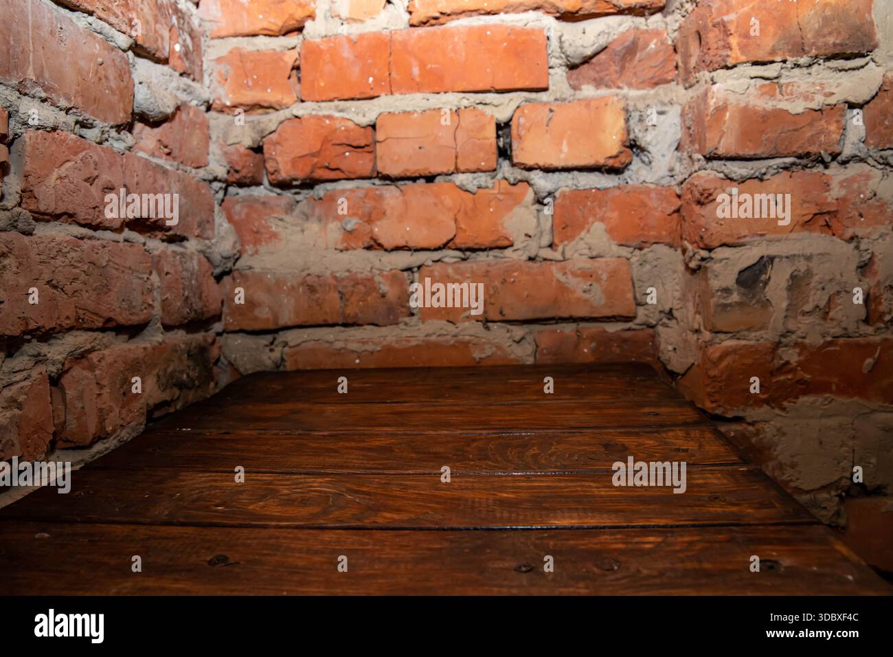 Empty wooden table against old brick wall interior background with copy space Stock Photo