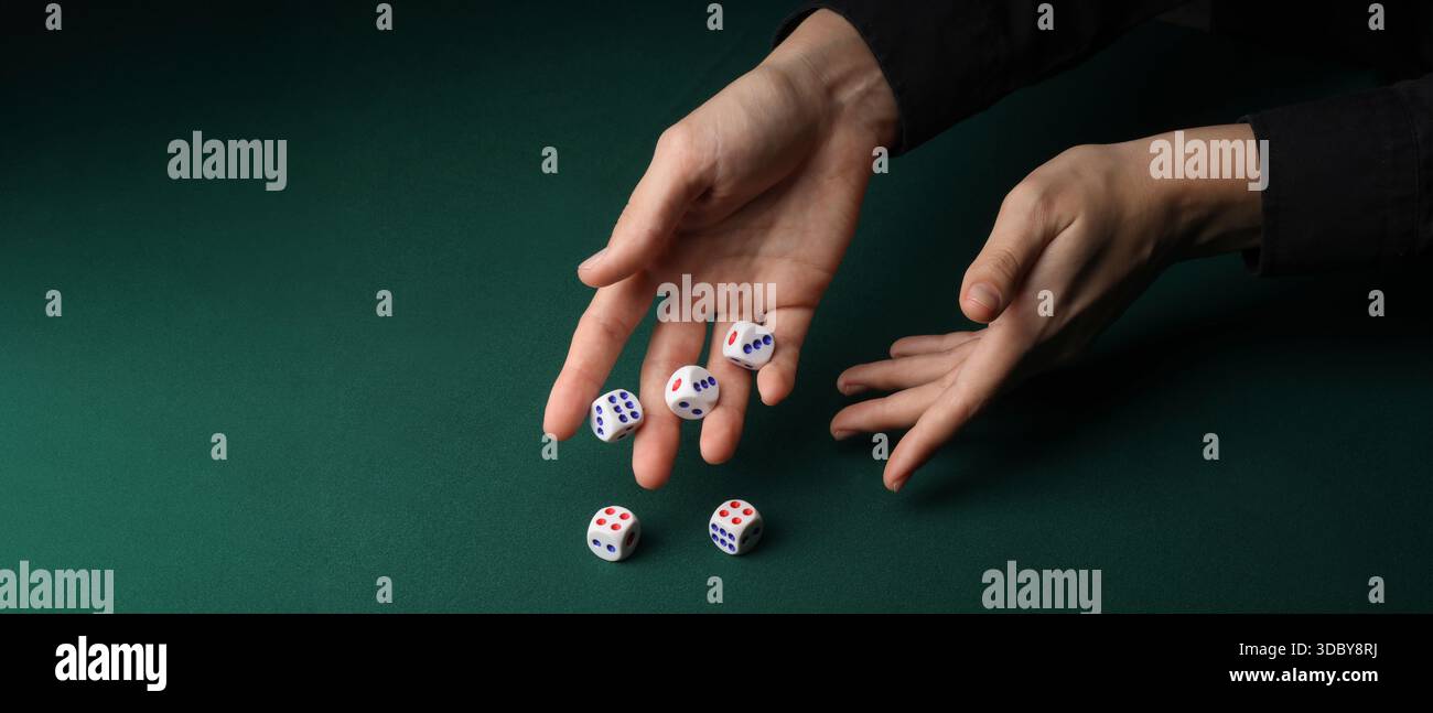 Hands throwing game dices on green background with space for text Stock Photo