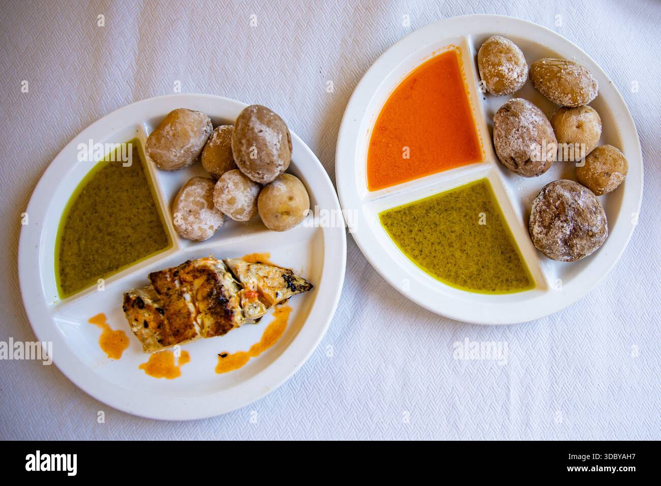 Tenerife papas arrugadas potatoes with green mojo sauce and grilled fish Stock Photo