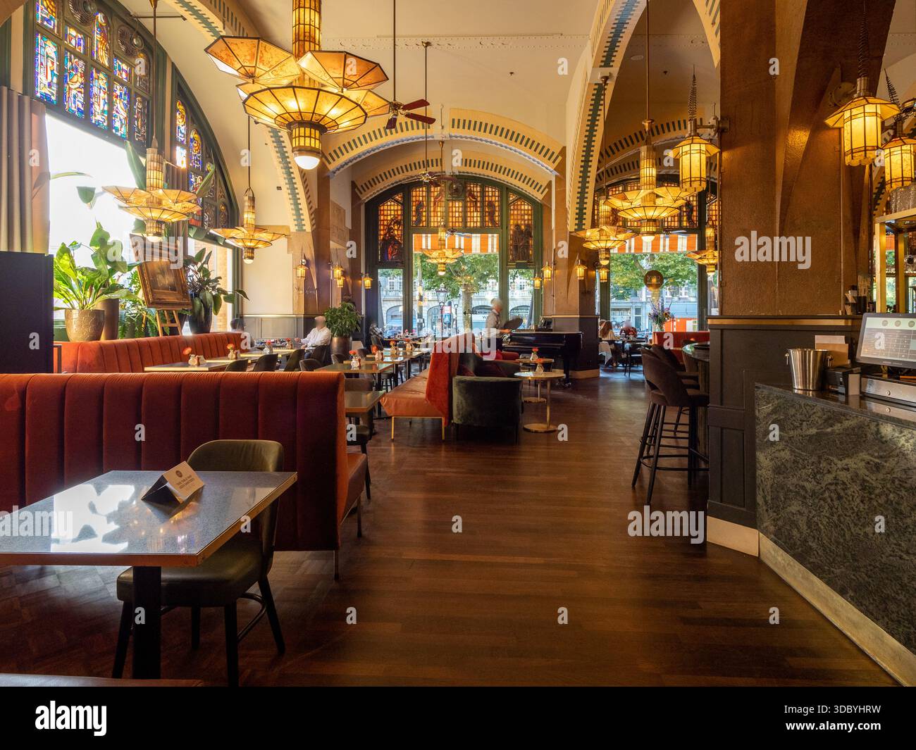 Art Nouveau café interior in Amsterdam with stained glass, chandeliers and velvet banquettes Stock Photo