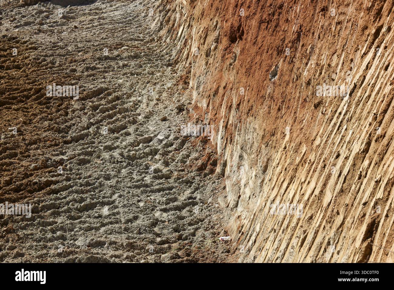Construction site trench excavation with textured soil layers and ...