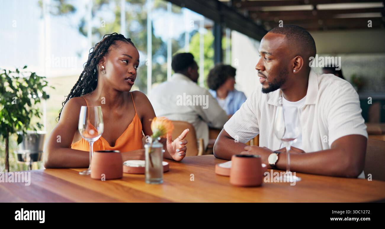 Conversation, date and serious with couple in restaurant together for bonding or relationship. Break, discussion and feedback with people at table in Stock Phot