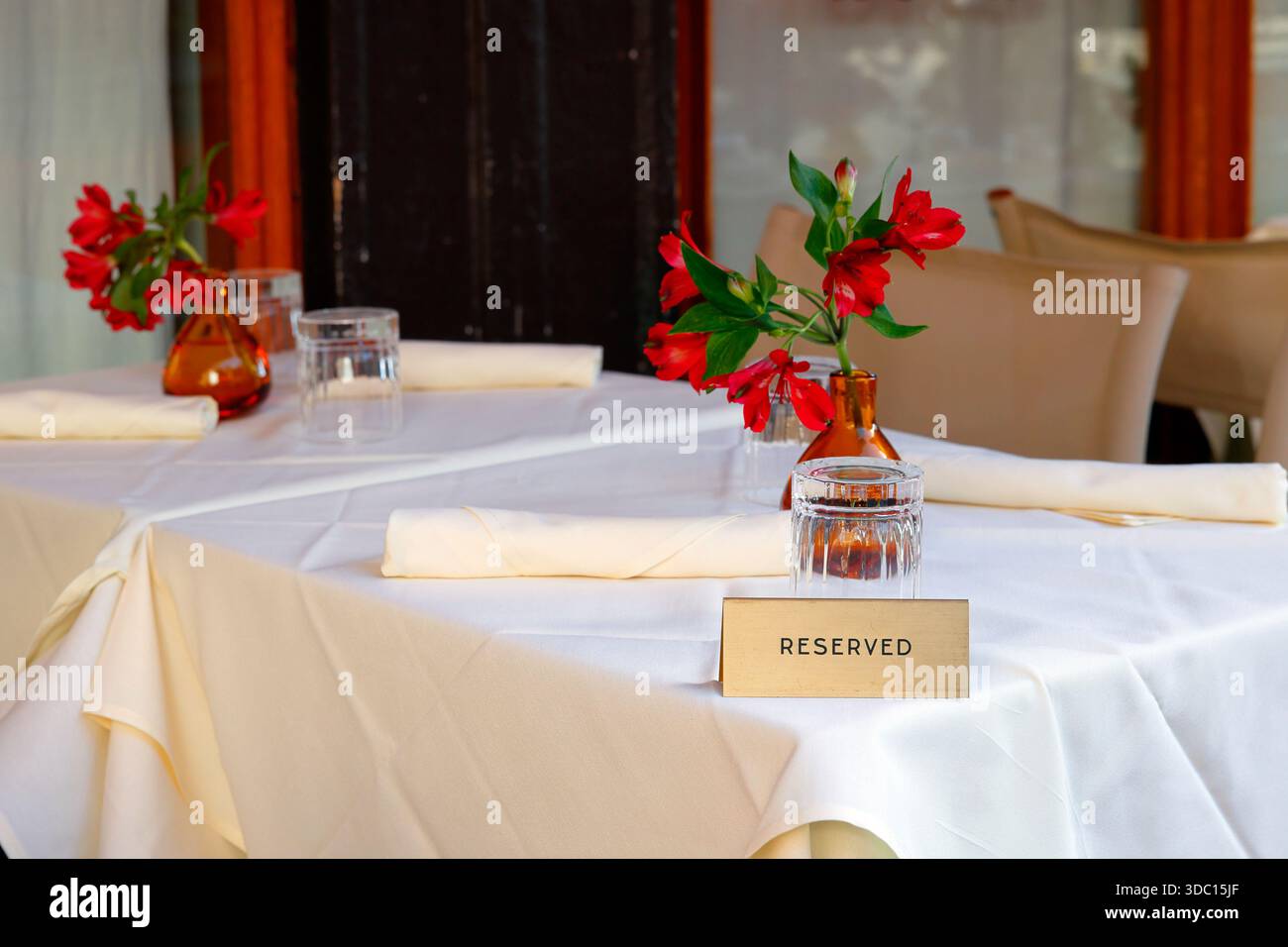 A fine dining table setting with a "Reserved" placeholder at a restaurant Stock Photo