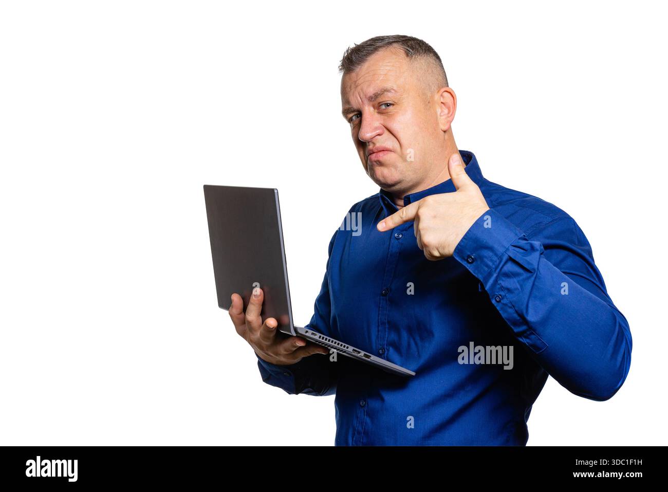 Man gesturing approval while holding laptop, success and positive feedback Stock Photo