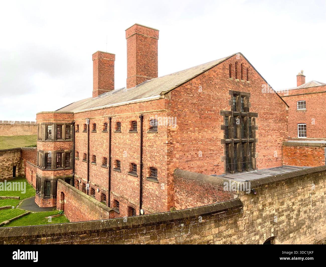 Lincoln Castle and its medieval stone towers with Lincolnshire Cathedral rising behind viewed  across the historic grounds in Lincoln Lincolnshire - Smartphone Captured Stock Image