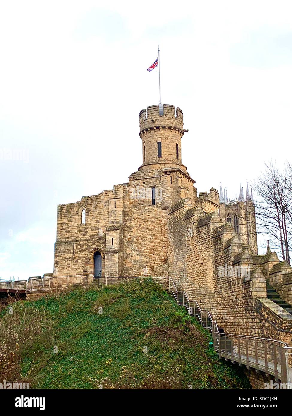 Lincoln Castle and its medieval stone towers with Lincolnshire Cathedral rising behind viewed  across the historic grounds in Lincoln Lincolnshire - Smartphone Captured Stock Image