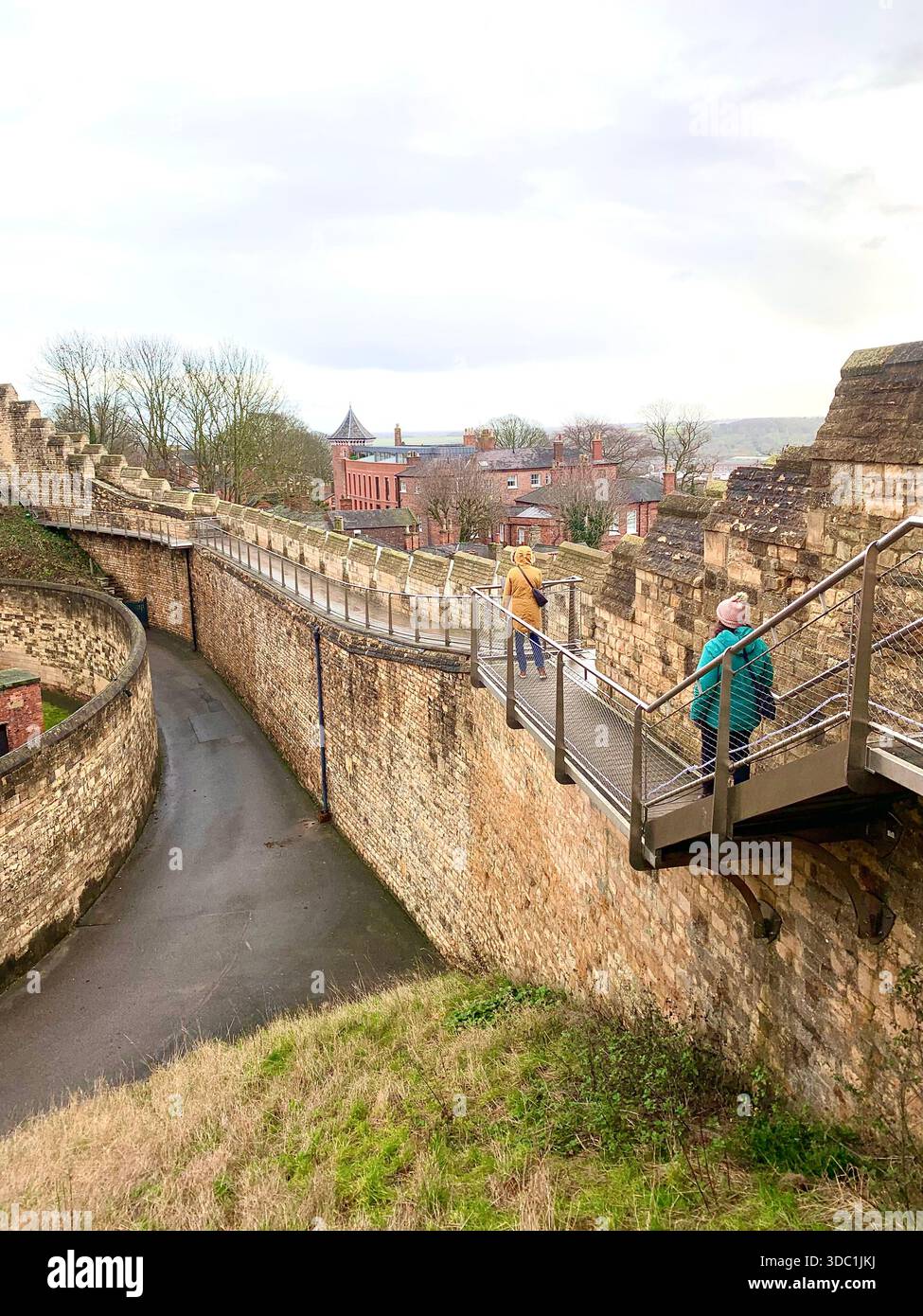 Lincoln Castle and its medieval stone towers with Lincolnshire Cathedral rising behind viewed  across the historic grounds in Lincoln Lincolnshire - Smartphone Captured Stock Image