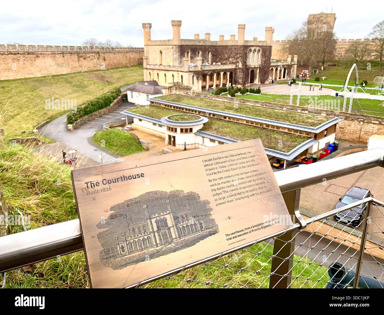 Lincoln Castle and its medieval stone towers with Lincolnshire Cathedral rising behind viewed  across the historic grounds in Lincoln Lincolnshire - Smartphone Captured Stock Image