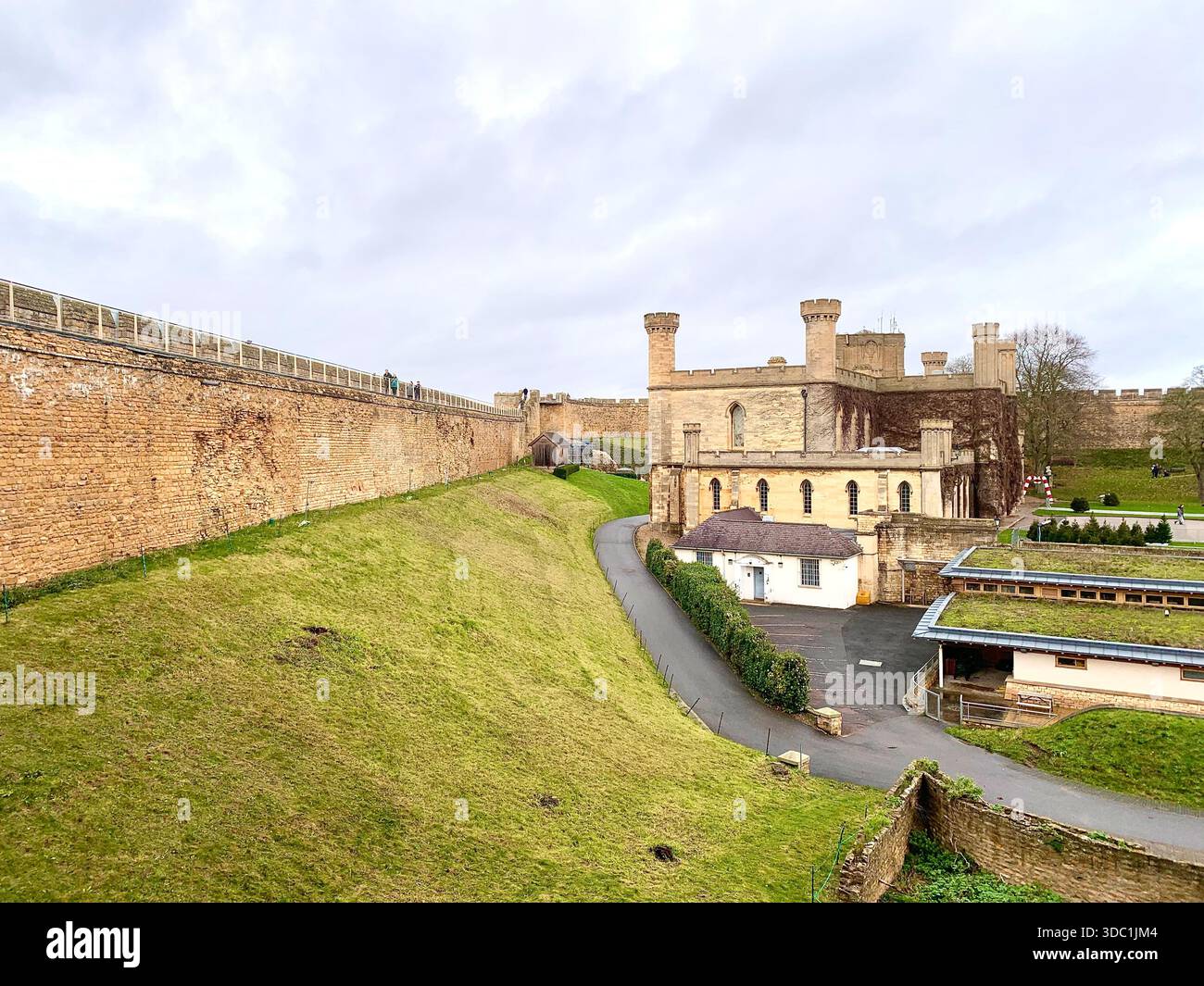 Lincoln Castle and its medieval stone towers with Lincolnshire Cathedral rising behind viewed  across the historic grounds in Lincoln Lincolnshire - Smartphone Captured Stock Image