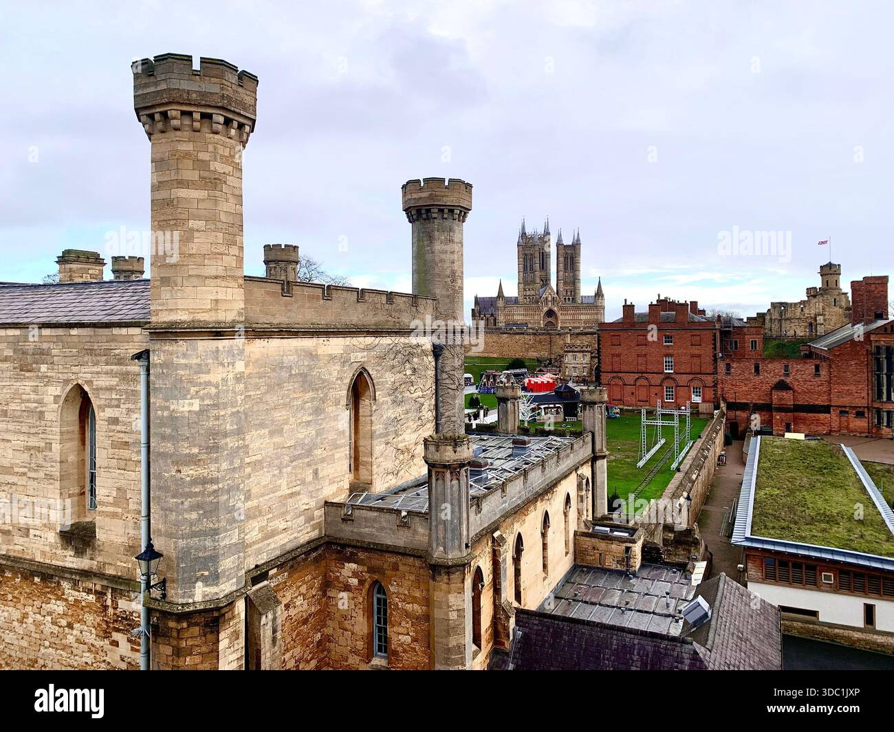 Lincoln Castle and its medieval stone towers with Lincolnshire Cathedral rising behind viewed  across the historic grounds in Lincoln Lincolnshire - Smartphone Captured Stock Image