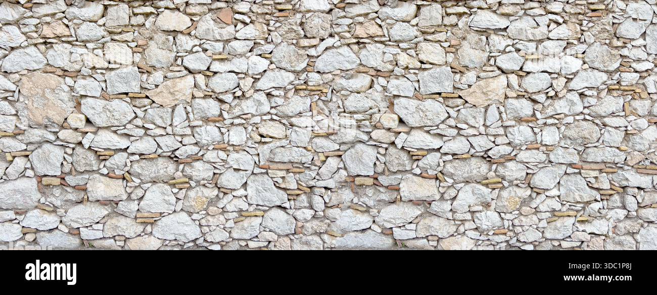Ancient stone wall constructing rustic natural background texture Stock Photo