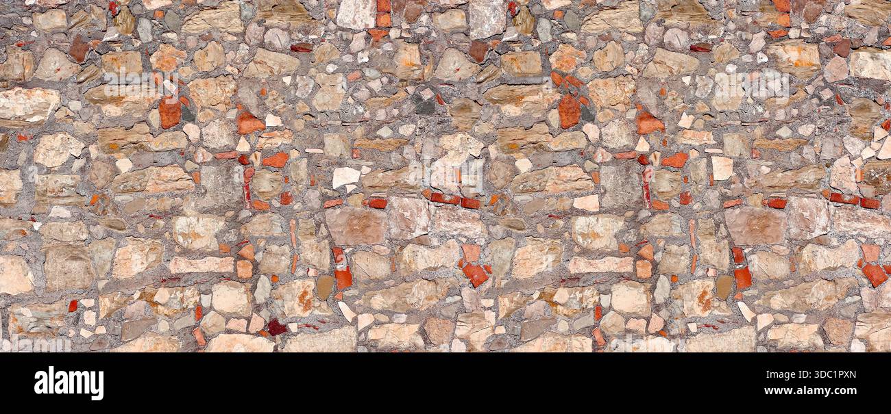 Ancient stone and brick wall presenting a rustic surface texture Stock Photo