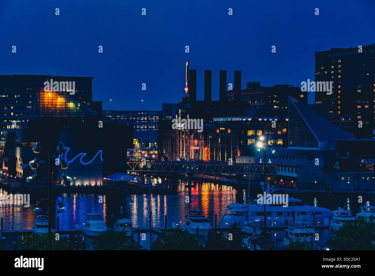 Boats and city lights surrounding Baltimore's iconic Inner Harbor Stock ...