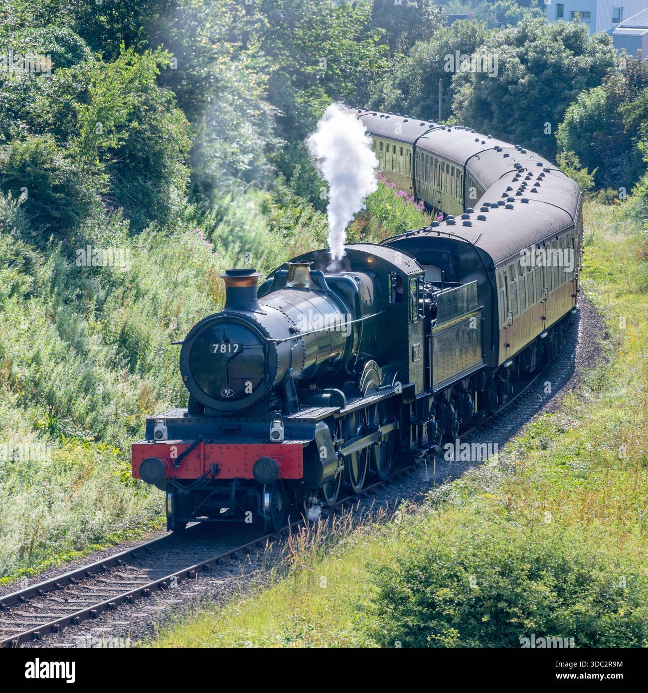 Steam locomotive 7812, Erlestoke Manor, pulling a passenger train past ...