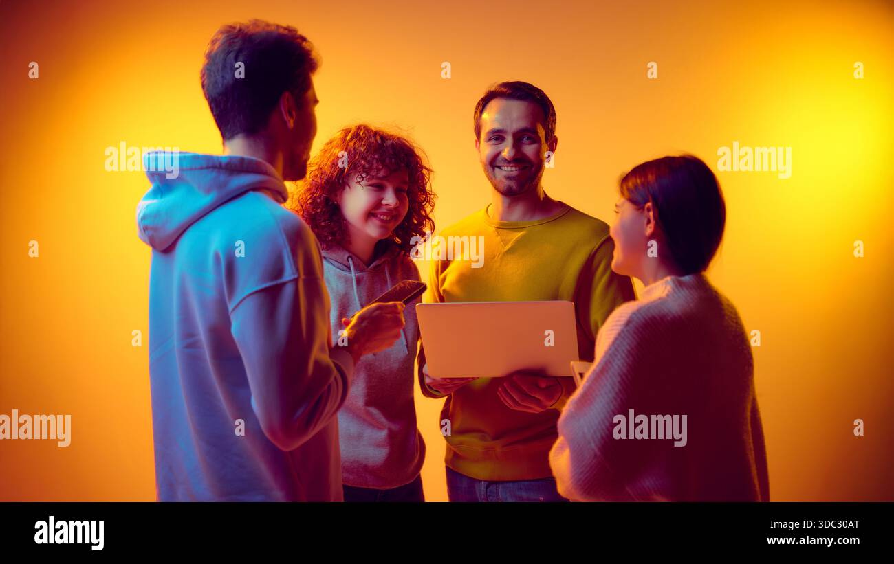 Business team interacting around laptop during digital discussion Stock ...