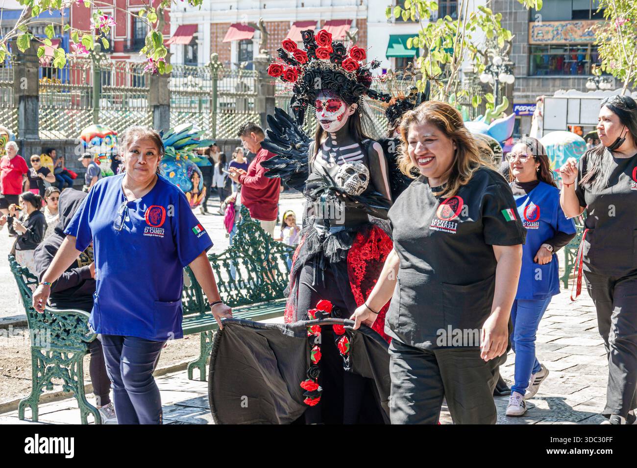 Puebla Mexico,Zocalo city square park,Day of the Dead Dia de Muertos event,La Catrina performer adult female,red black costume floral crown skull make Stock Photo