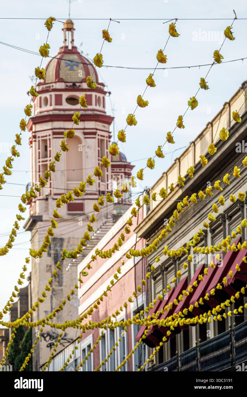 Puebla Mexico,Calle 5 Cinco de Mayo,day of the dead Dia de Muertos,festival decorations,papel picado style floral garlands,colonial architecture,churc Stock Photo