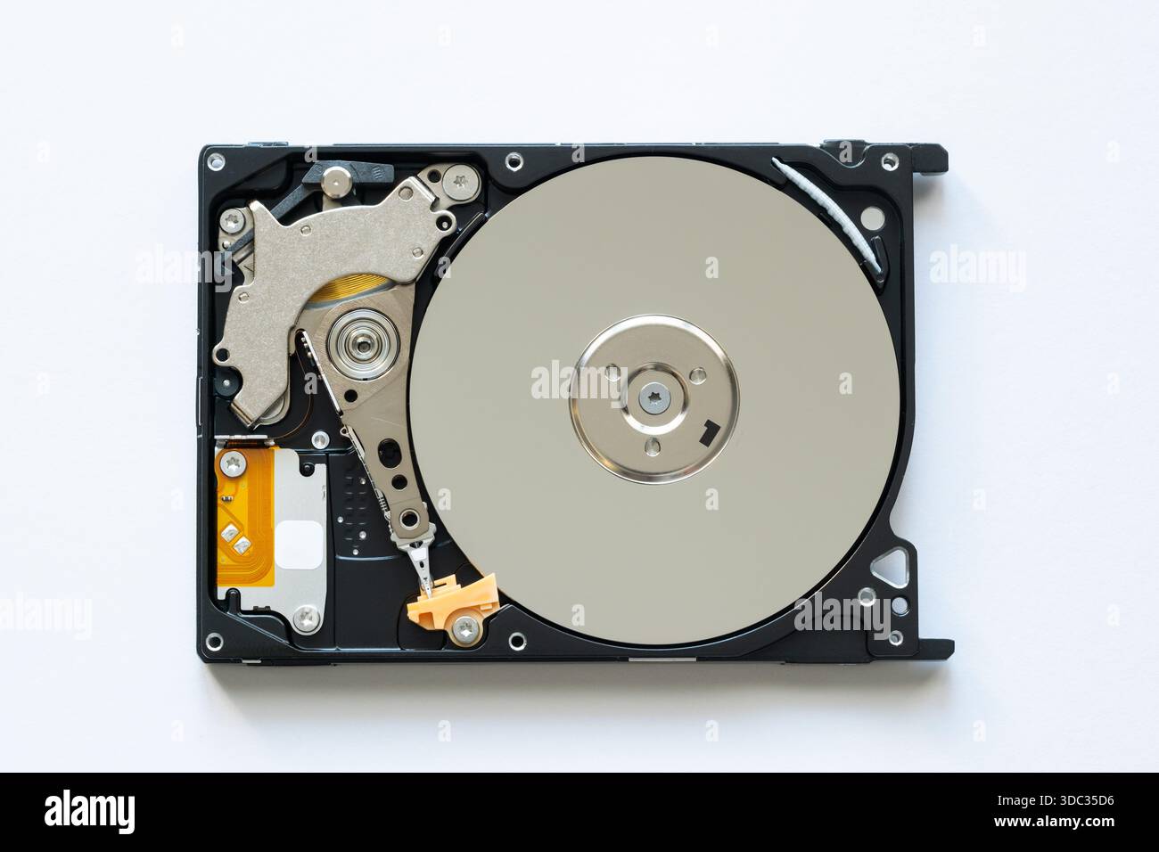 An old physical hard drive with read and write head Stock Photo
