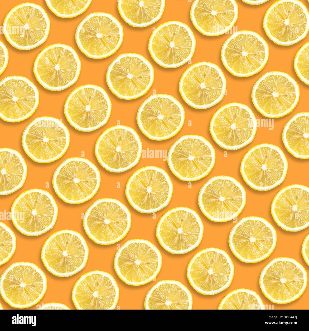Citrus fruit pattern. Lemon slices on orange background Stock Photo