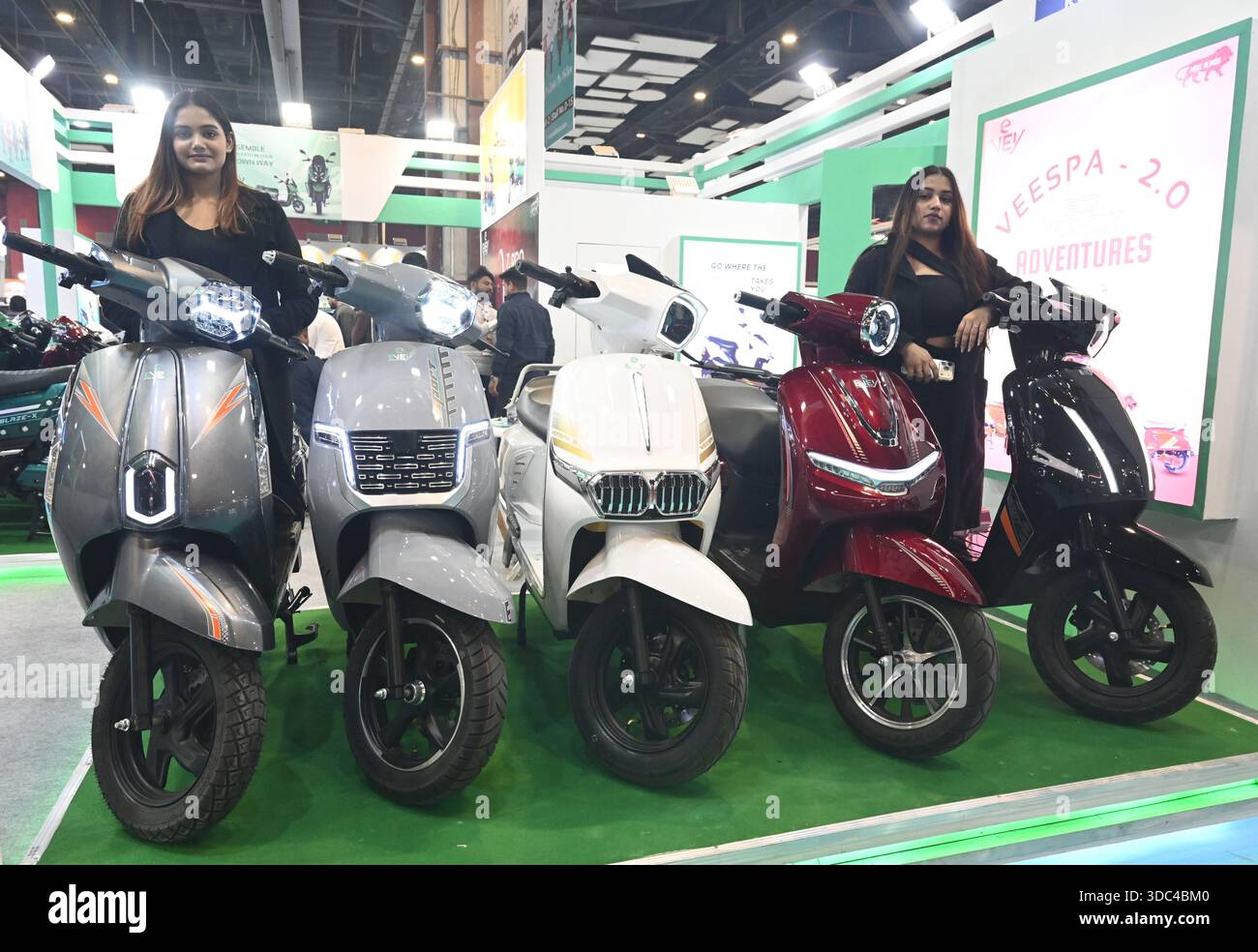 New Delhi, India. 19th Dec, 2025. NEW DELHI, INDIA - DECEMBER 19: People  look at EV cars, bikes, scooters and battery rickshaw during the first day  of 23rd EVEXPO DELHI 2025 at