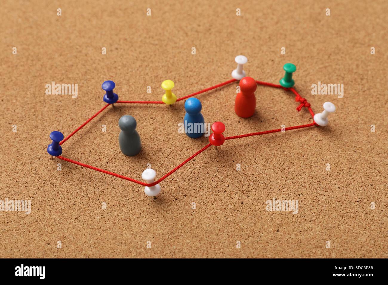 Connected pins with thread on board. Link concept Stock Photo