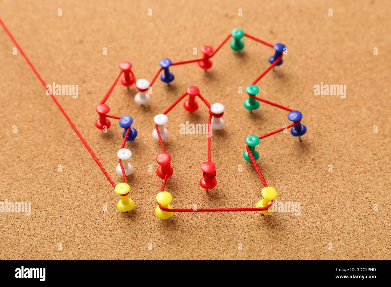 Connected pins with thread on board. Link concept Stock Photo
