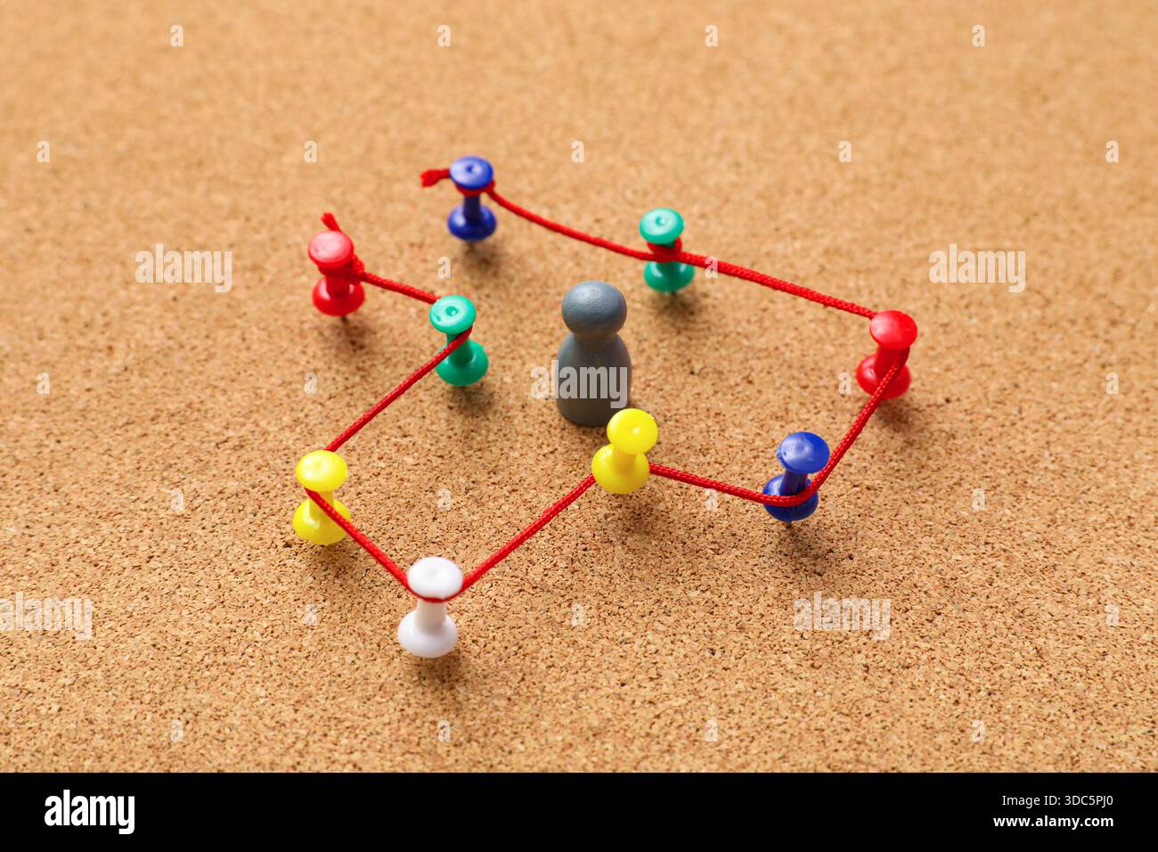 Connected pins with thread and figure on board. Link concept Stock Photo