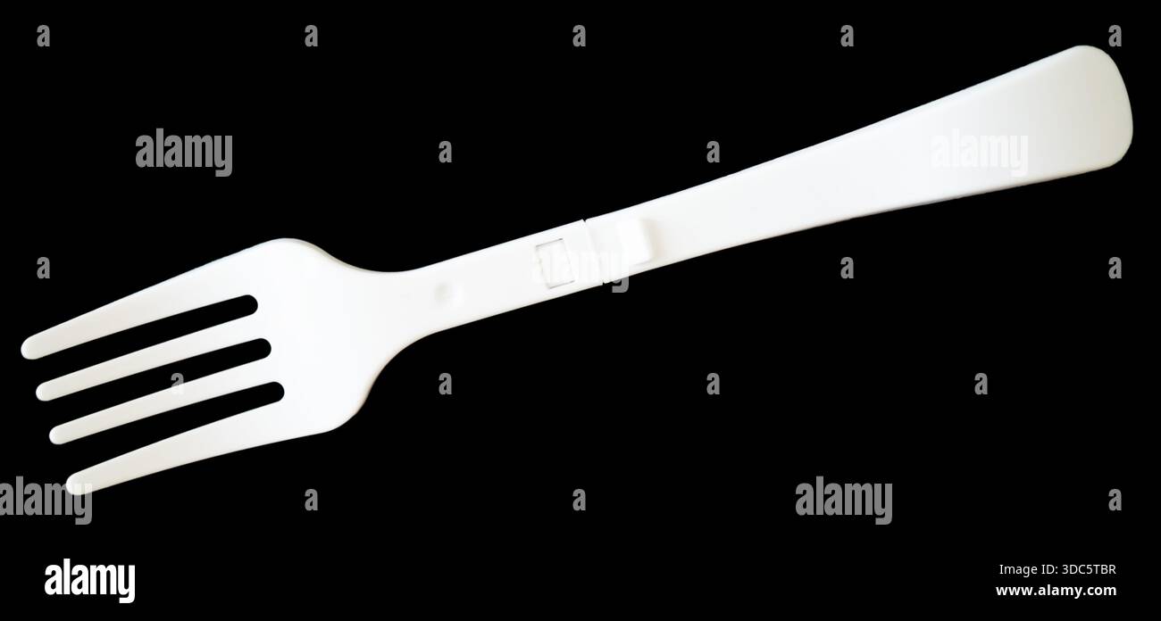 Plastic fork isolated on black background Stock Photo
