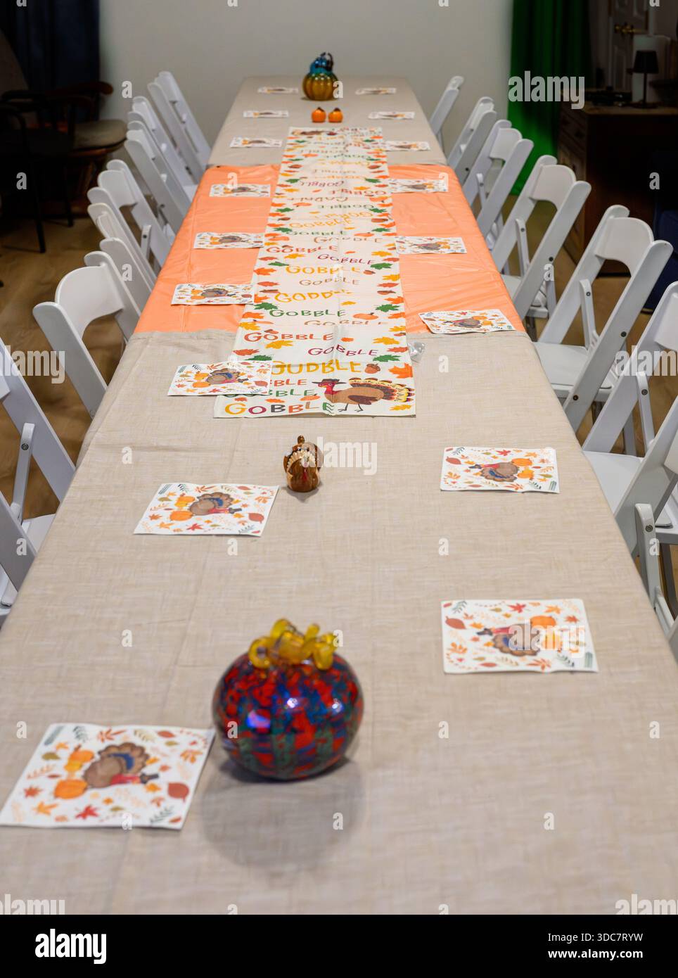 Long table with chairs set for thanksgiving dinner Stock Photo