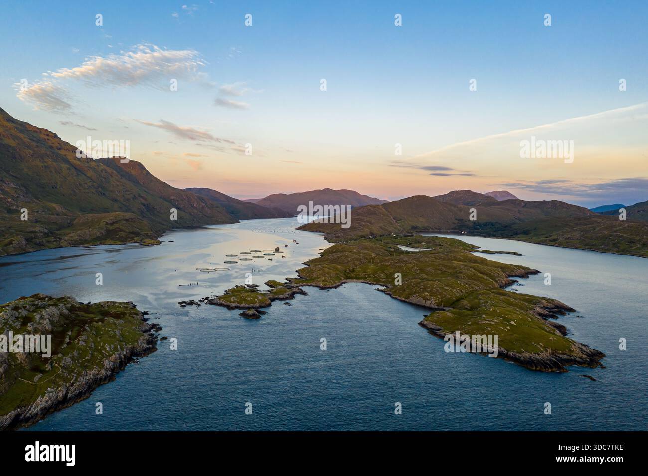 A tranquil aerial view shows a chain of green islands lining a winding ...