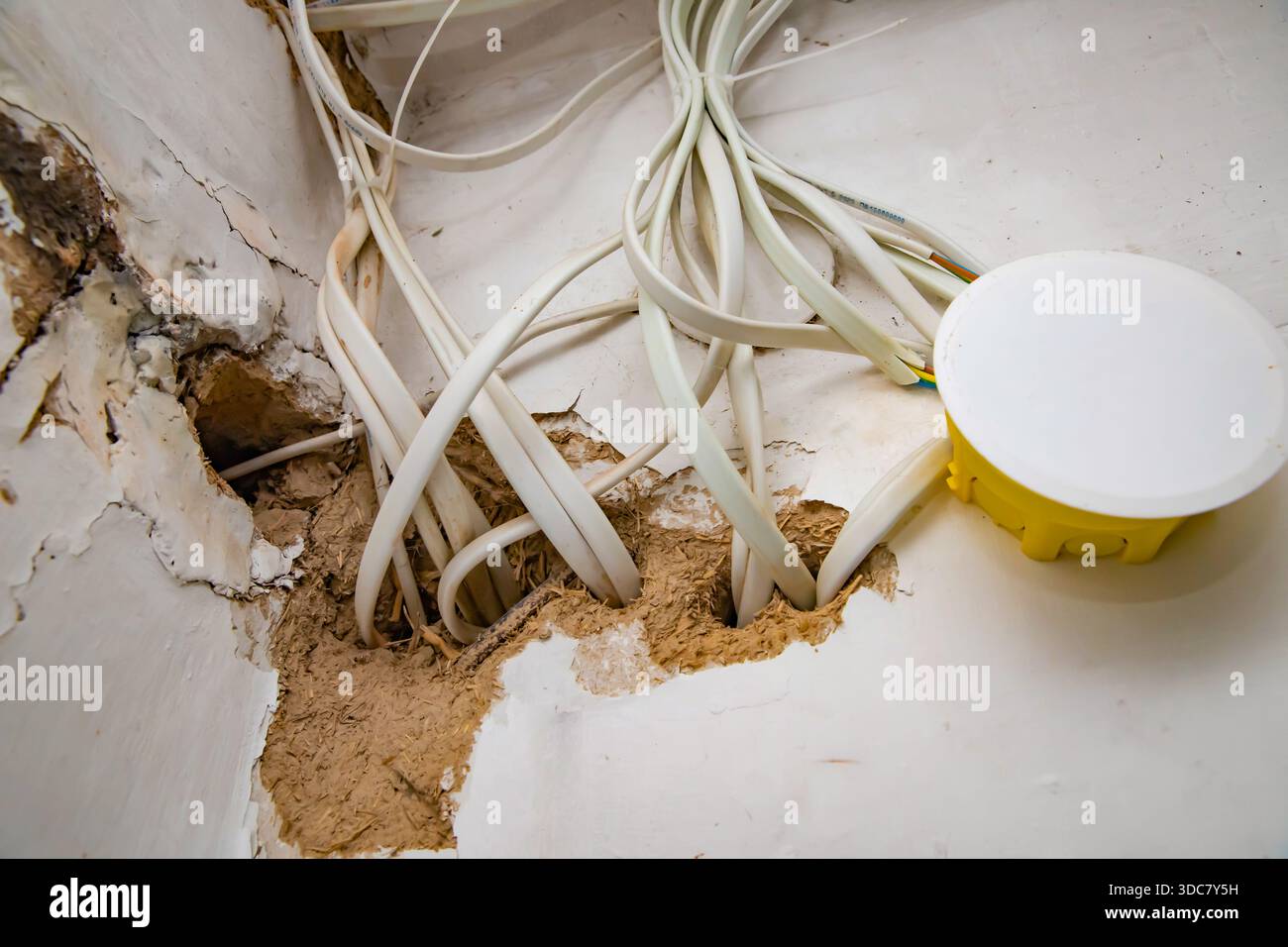 Electrical wiring cables and junction box exposed inside damaged wall ...
