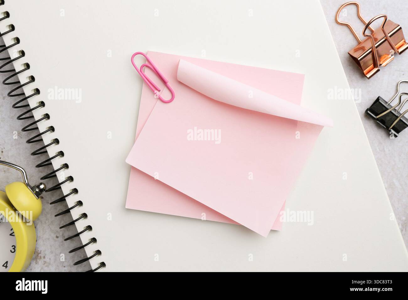 Blank notes, notebook, binder clips and alarm clock on table, flat lay Stock Photo