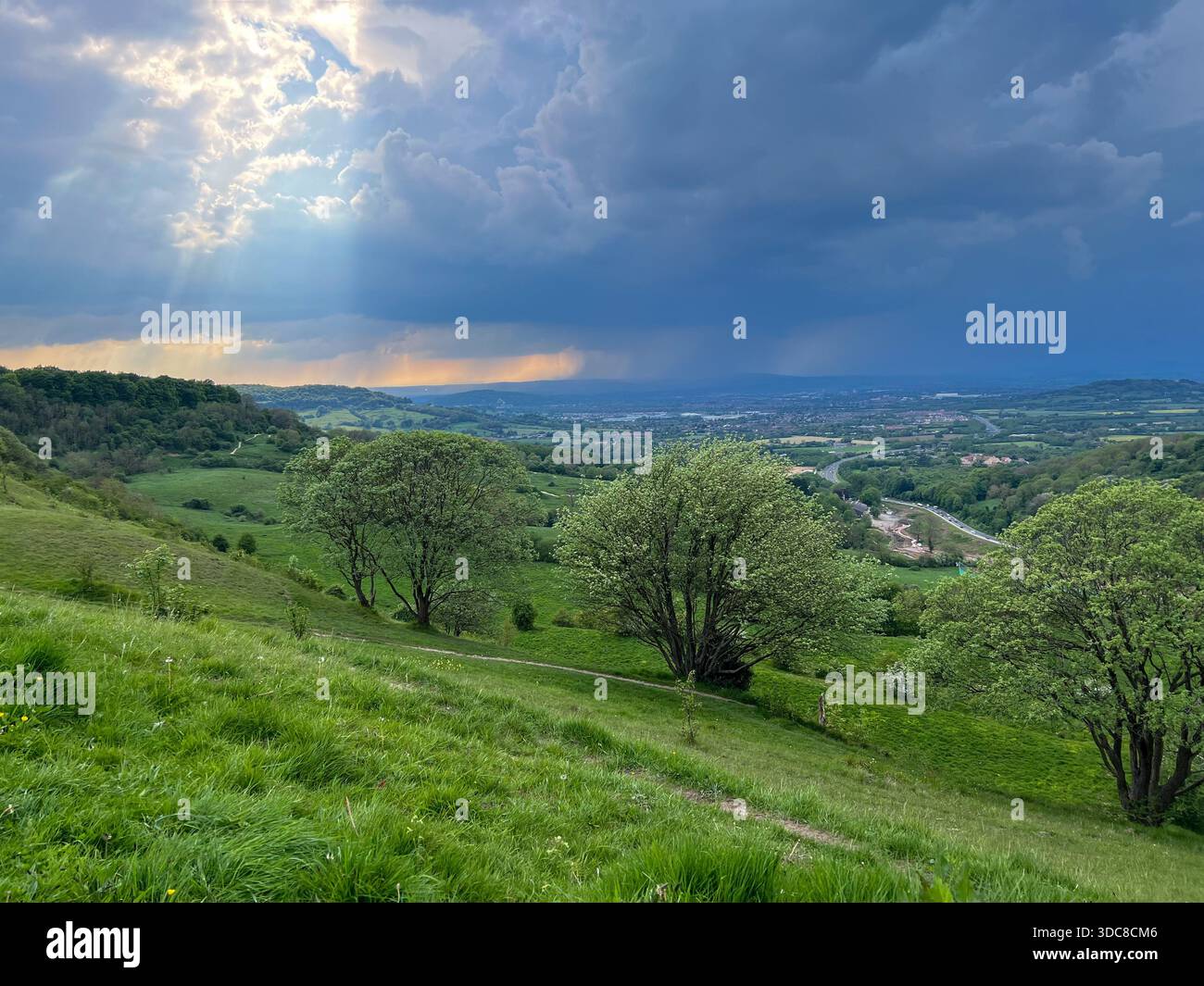 Dramatic Sun Rays Over Rolling Cotswolds Hills, Gloucestershire, England - Smartphone Captured Stock Image