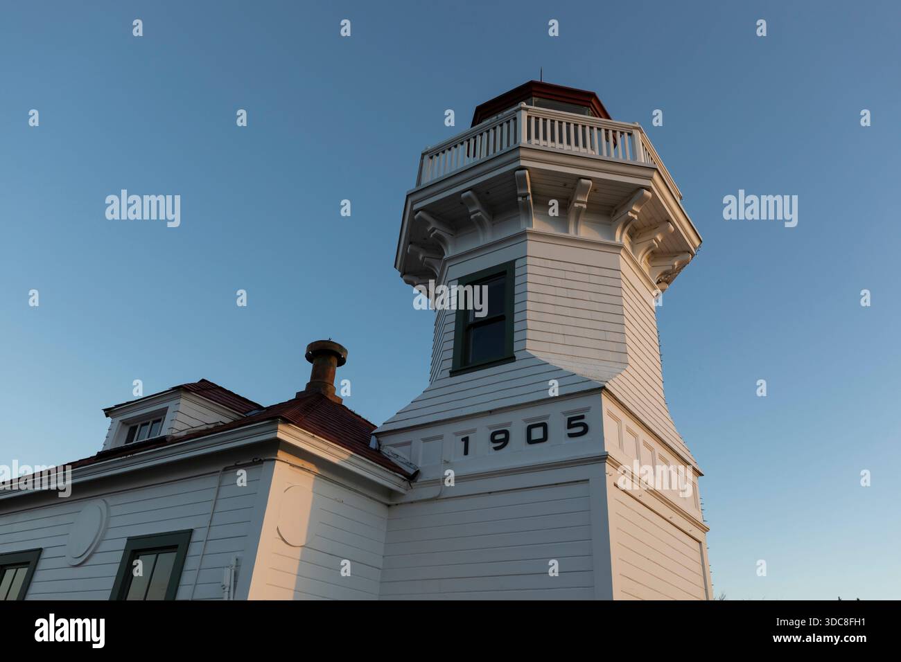 View of the historical Mukilteo Light as the sun sets in Mukilteo, Washington. Stock Photo