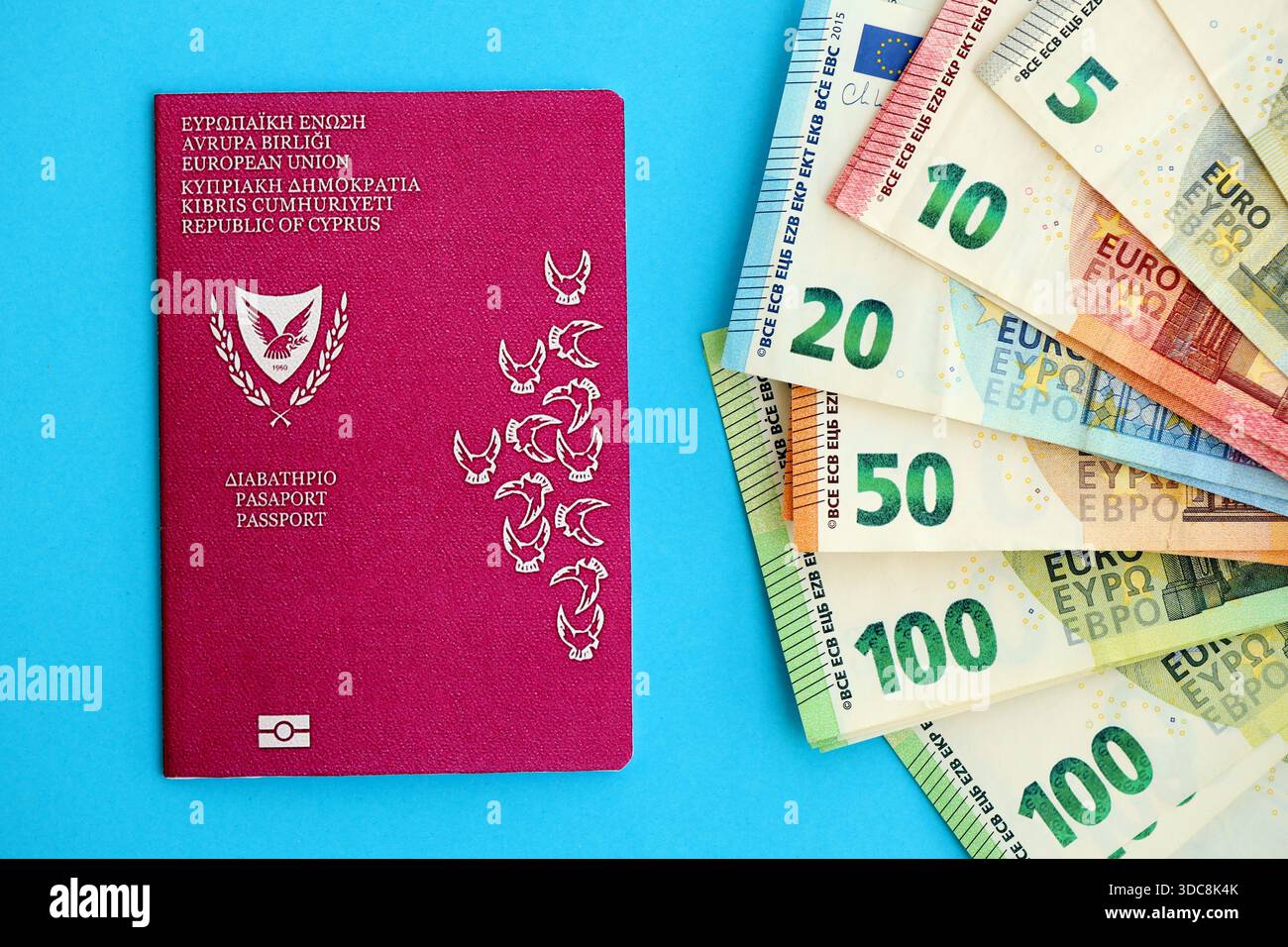 Kyprus passport lies with euro money banknotes on blue background close up. Salary and pension in Europe concept Stock Photo