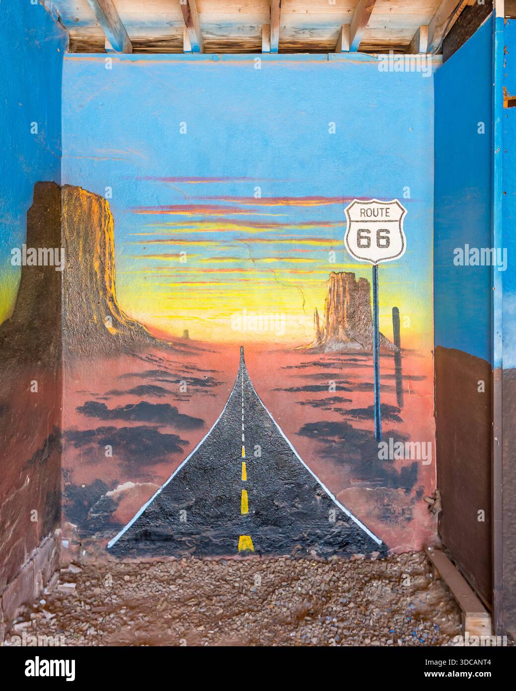 On ROUTE 66, mural depicts heading west into the desert sunset