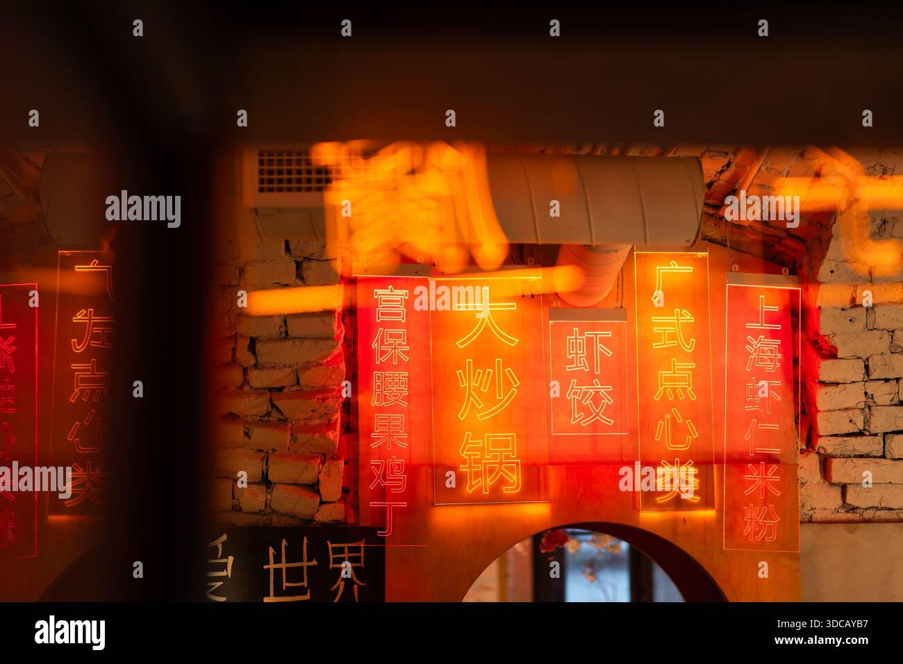 Traditional interior and atmosphere of Chinese restaurant space with neon menu signs and lanterns. Stock Photo