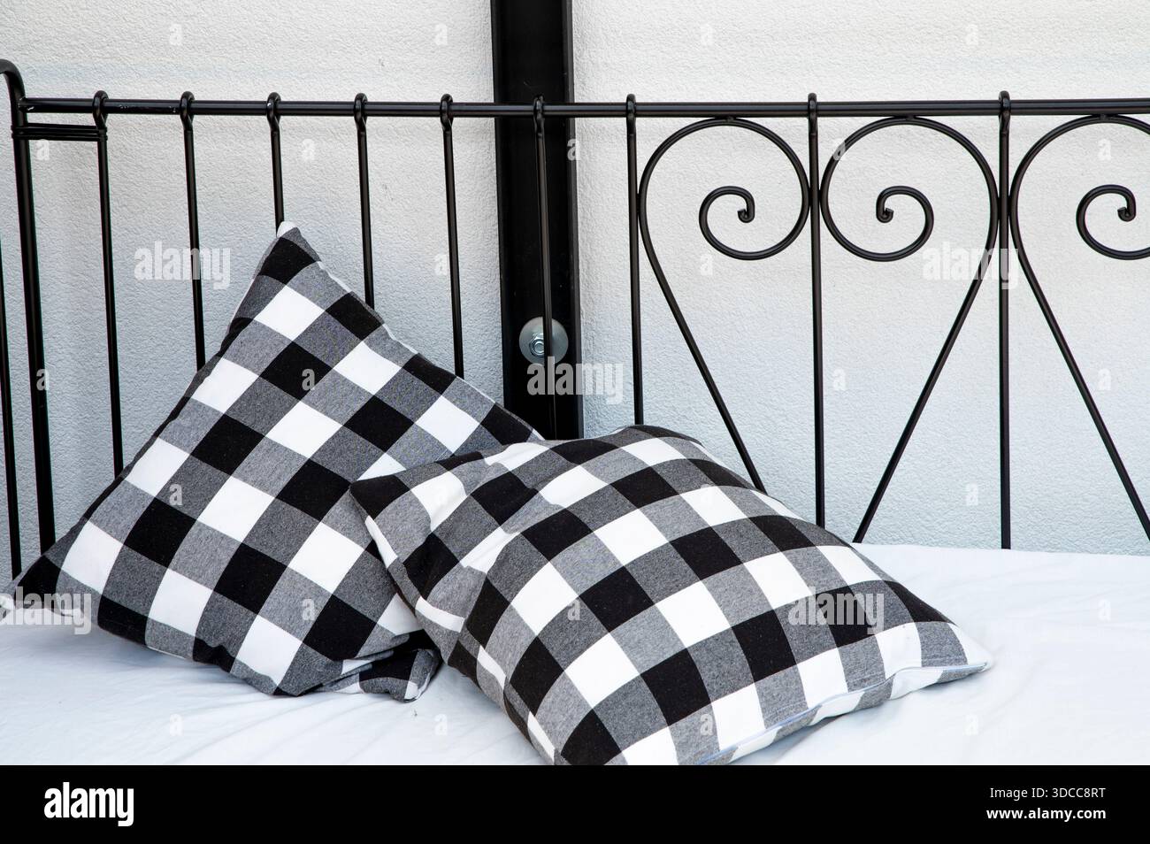 Two Black and White Checkered Pillows on a Bed Stock Photo
