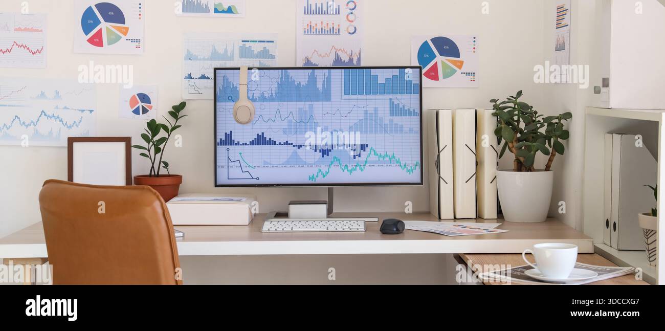 Data scientist's workplace with computer and diagrams in office Stock Photo