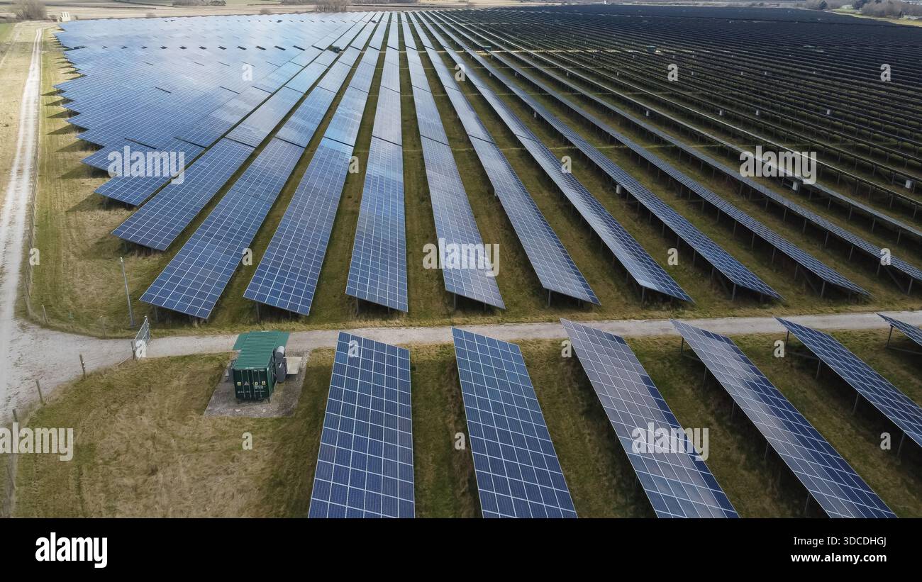 Aerial view of rows of solar panels at a large solar farm producing ...