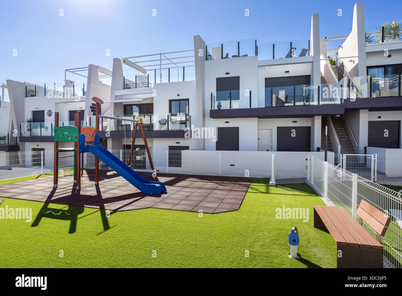 Urban apartment complex featuring safe enclosed playground with slide ...