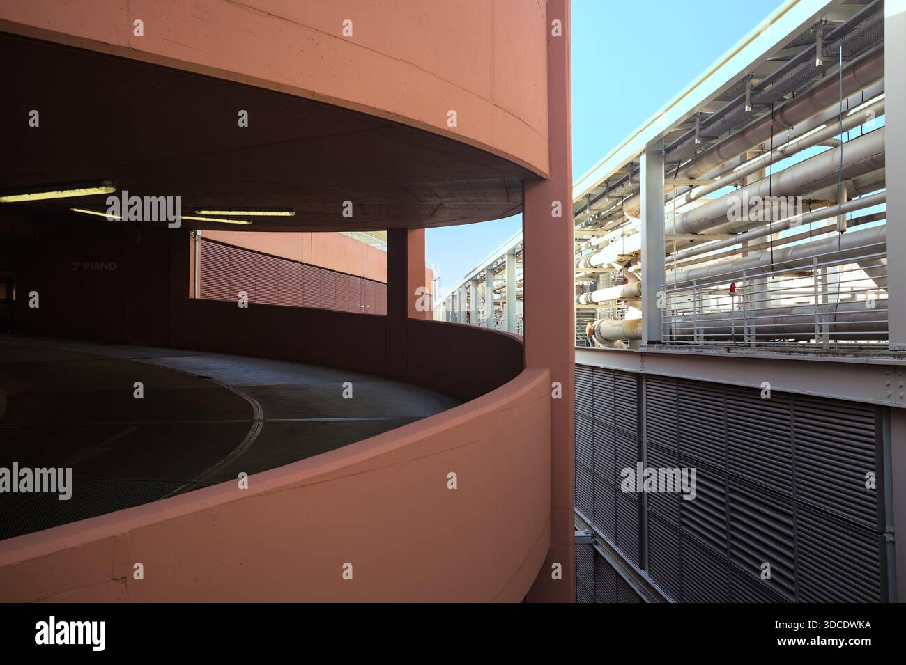 Spiral shaped ramp of a parking lot next to another building seen from ...