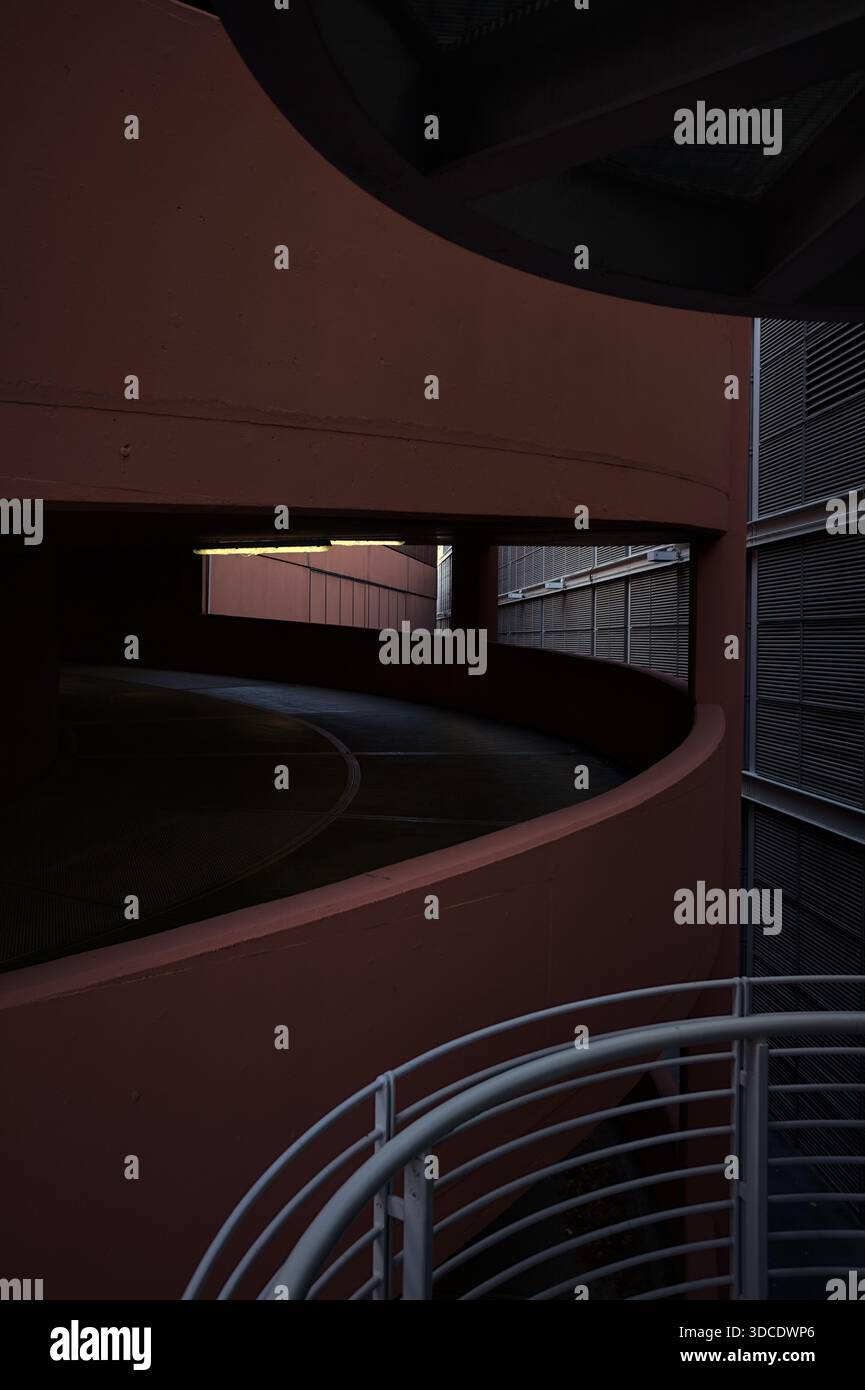 Spiral shaped ramp of a parking lot next to another building seen from ...