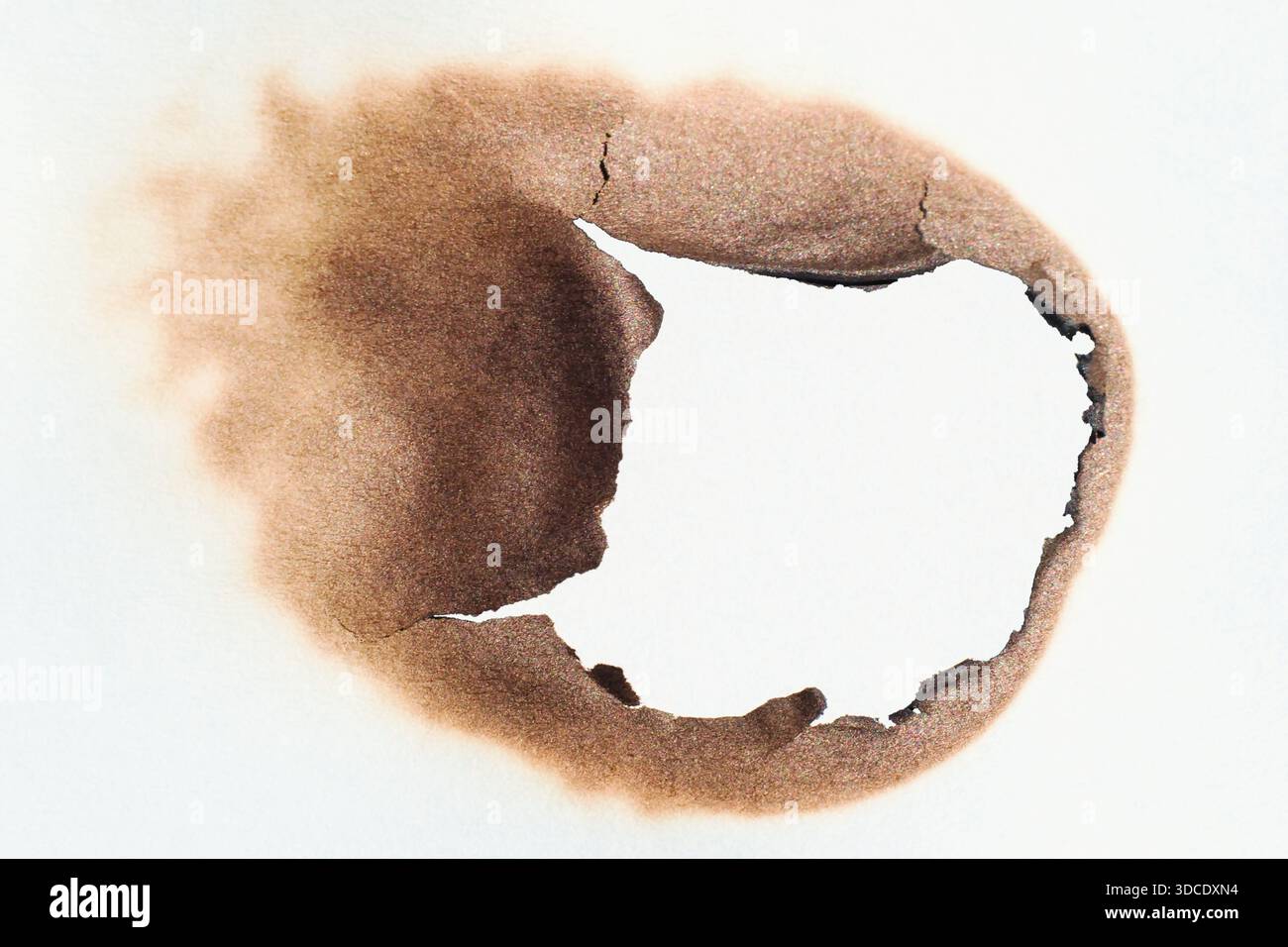 Burned hole in the paper Stock Photo