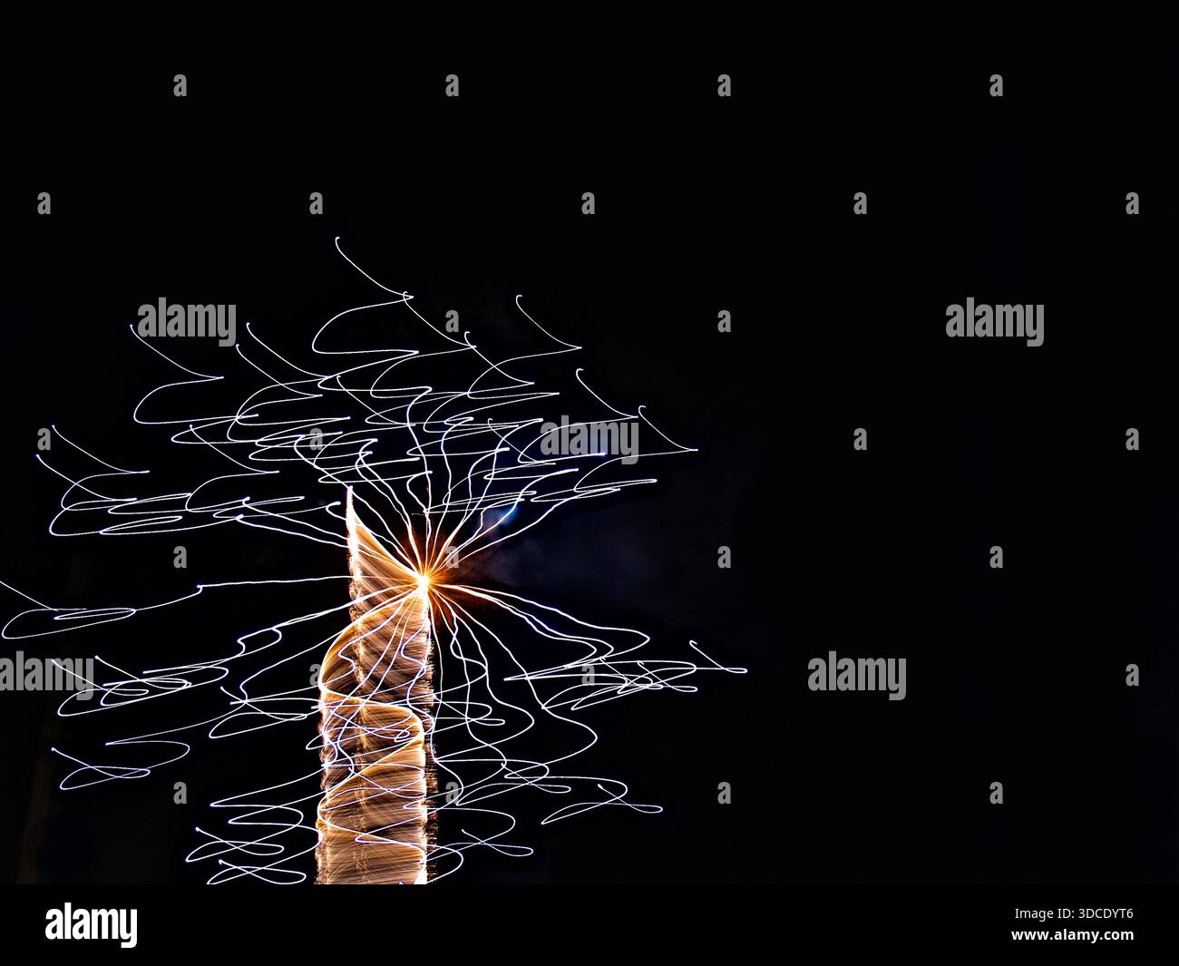 Dynamic display of light trails against a dark background creates an abstract, electrified spark effect. Stock Photo