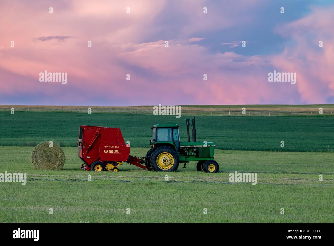Swift Tractor Swift Current, SK, Canada- June 28, 2025: A John Deere tractor pulling ...