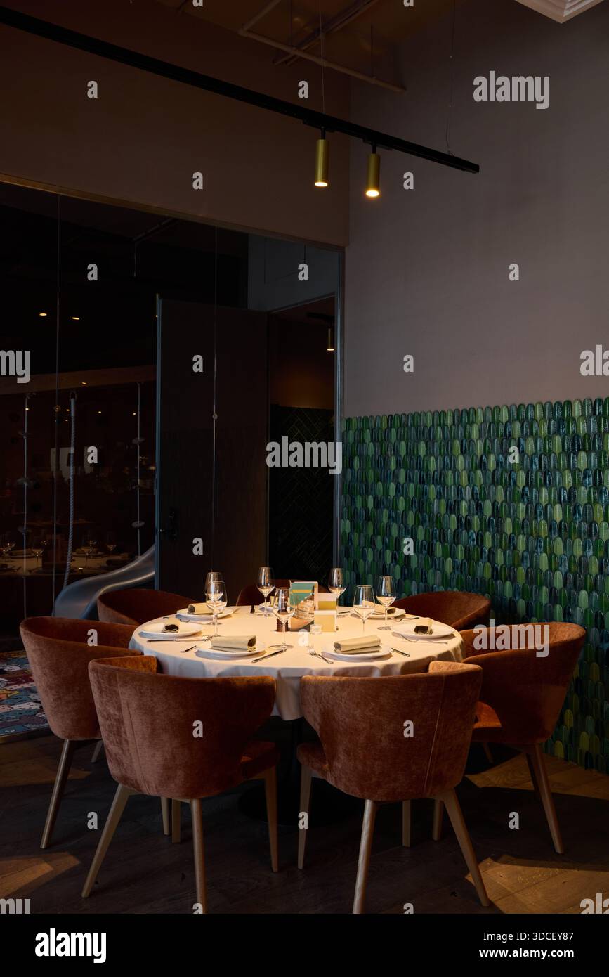 Dining setup in a modern restaurant with chairs and table Stock Photo